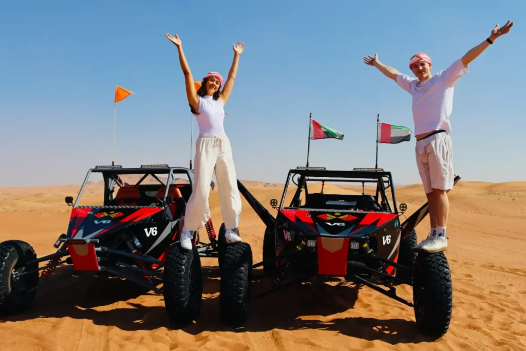 Couple Standing on the V6 Engine Dune Buggy Dubai Tour